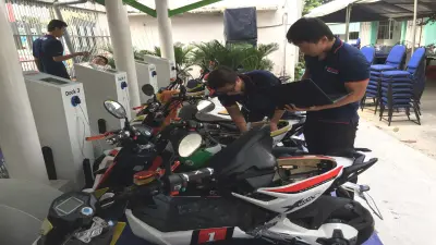 Two students, Hoang Anh Tu (left) and Vo Ha Trung (right), are doing the last checks before the launch event in Ho Chi Minh City