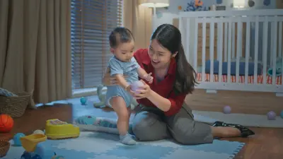Young Asian mother playing with her baby.