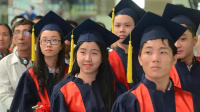 New graduates wearing ceremonial caps and cloaks.